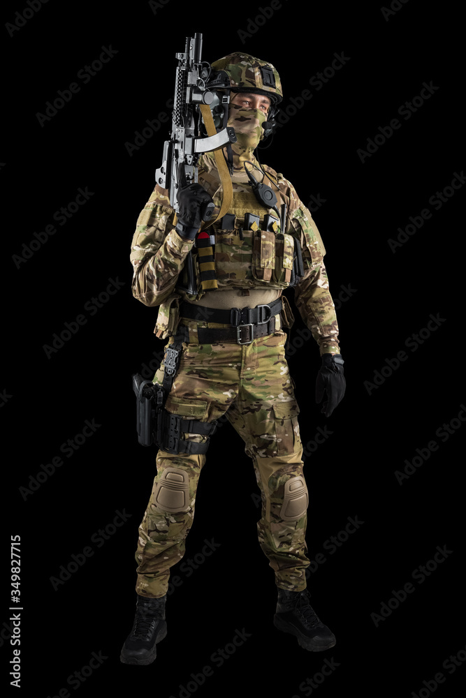 Soldier holding assault rifle. Uniform conforms to special services of the Russian Federation. Shot in studio. Isolated with clipping path on black background Soldier holding assault rifle. Uniform conforms to special services of the Russian Federation. Shot in studio. Isolated with clipping path on black background