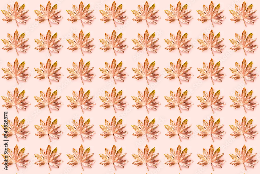 Beautiful Leaf Pattern. Leaves are painted in golden and copper metallic paint on pink background. Autumn minimalism. Isometric flat lay. Beautiful Leaf Pattern. Leaves are painted in golden and copper metallic paint on pink background. Autumn minimalism. Isometric flat lay.