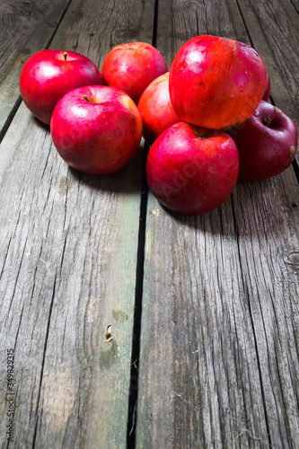 Red apples on wooden background. Copy space.