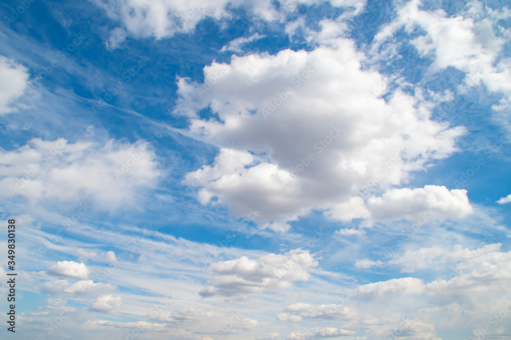 Horizontal view of a light, blue sky with white clouds. Airy, vibrant atmosphere Horizontal view of a light, blue sky with white clouds. Airy, vibrant atmosphere