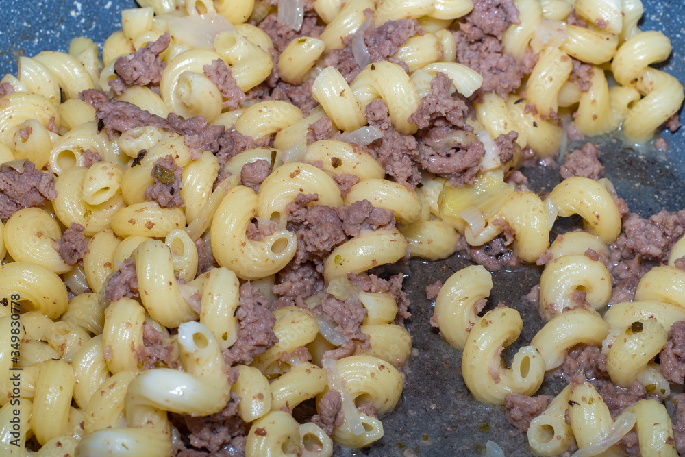 Homemade casually cooked pasta and stew food. Concept - laziness to cook food, quickly cooked dinner at home. Homemade casually cooked pasta and stew food. Concept - laziness to cook food, quickly cooked dinner at home.