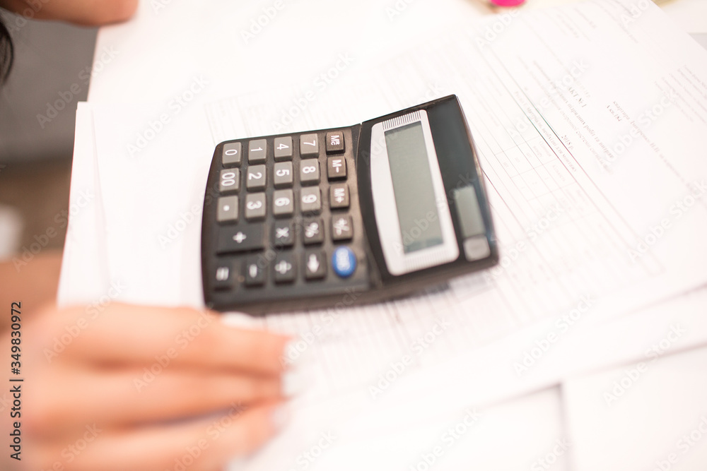 Old black calculator on the table. Close-up Old black calculator on the table. Close-up