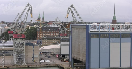 4K Helsinki Baltic Sea Finnish Bay lagoon, buildings and port construction cranes cloudy summer day video in Jatkasaari district in Finland capital, northern Europe