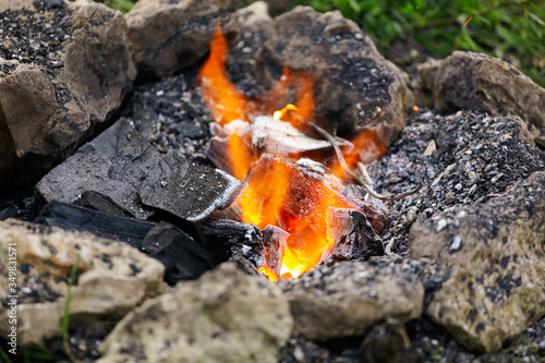 Burning coals with sparks on the nature.
