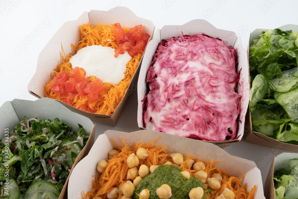 a set of different salads for vegetarians and raw foodists ready to eat in cardboard plates
