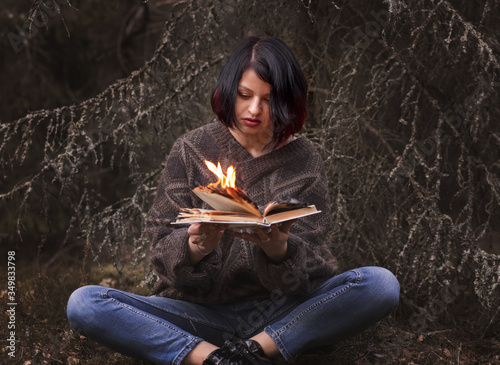the book burns in the hands of a woman