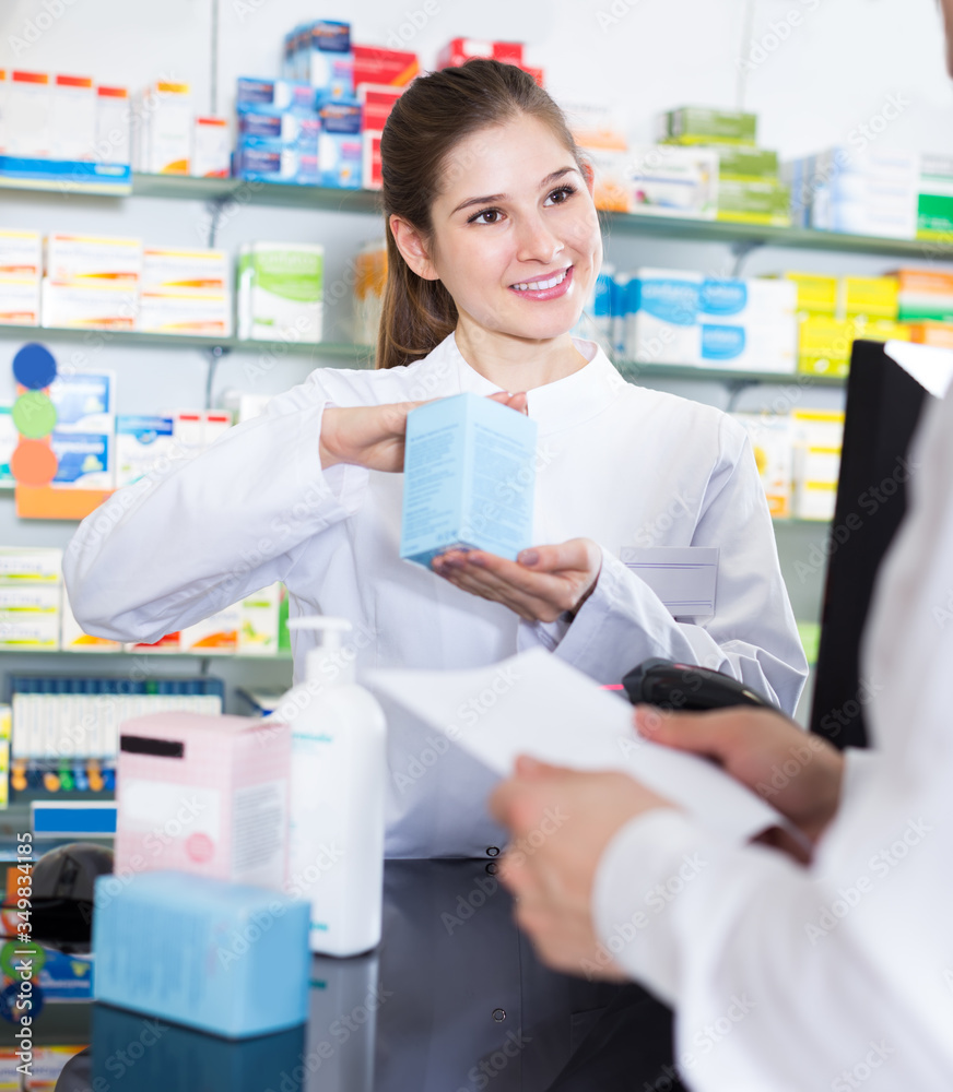 female pharmacist helps a man buy a drug