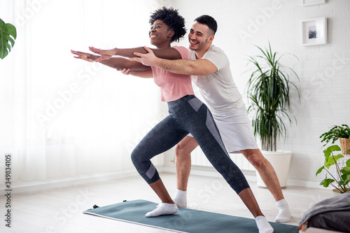 Multiethnic couple exercise at home early in the morning