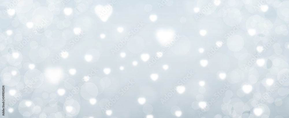 Glowing soft grey bokeh background. Spring concept. Blurred bokeh circles and hearth shapes. Website banner. Celebration. Christmas. Glowing soft grey bokeh background. Spring concept. Blurred bokeh circles and hearth shapes. Website banner. Celebration. Christmas.