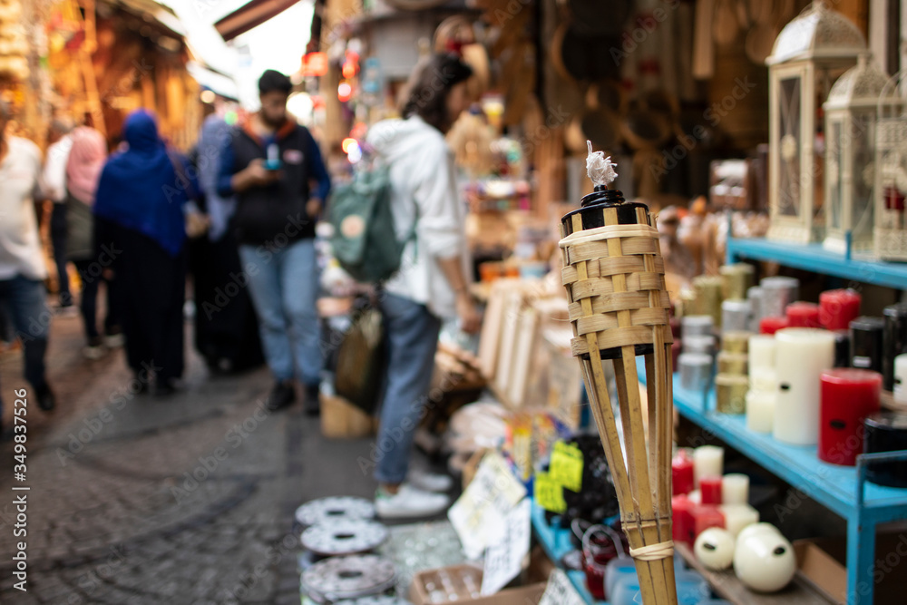 Naklejka premium Traditional bamboo torch single. Store for sale in inonu. In the background the street. Close-up.