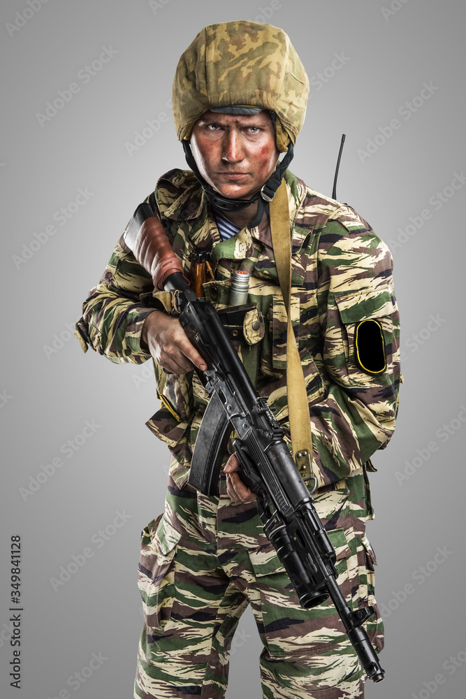 Male in uniform conforms to Russian army special forces (OMON) in War in Chechnya. Isolated on grey background Male in uniform conforms to Russian army special forces (OMON) in War in Chechnya. Isolated on grey background