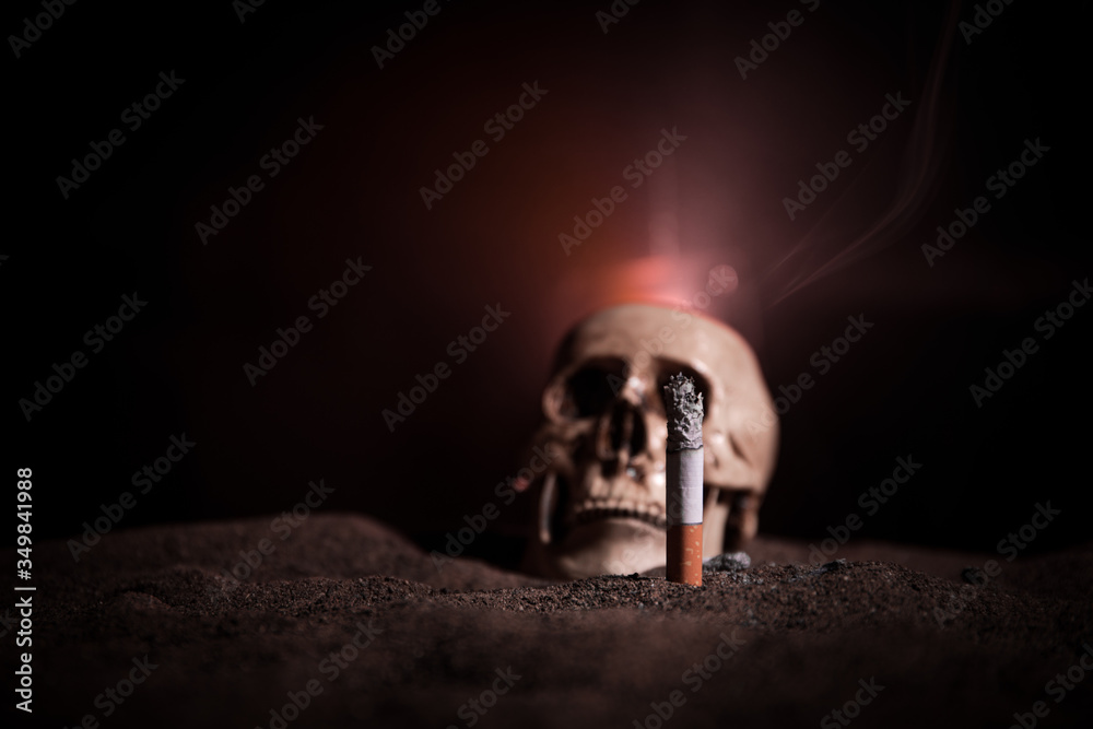Ashtray and butts cigarettes on dark background. Selective focus Ashtray and butts cigarettes on dark background. Selective focus