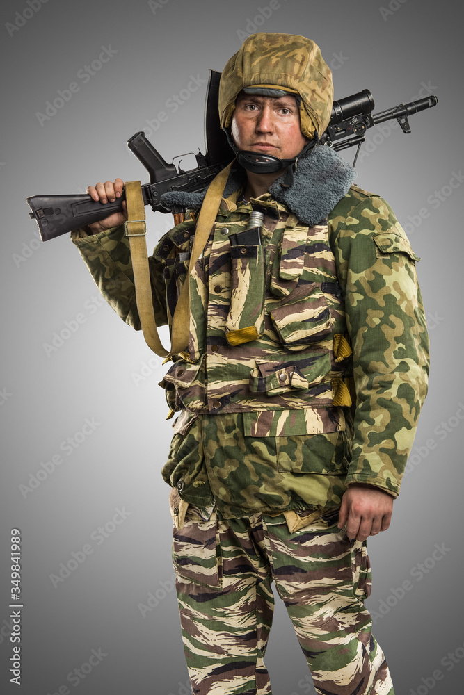 Male in uniform conforms to Russian army special forces (OMON) in War in Chechnya. Isolated on grey background Male in uniform conforms to Russian army special forces (OMON) in War in Chechnya. Isolated on grey background