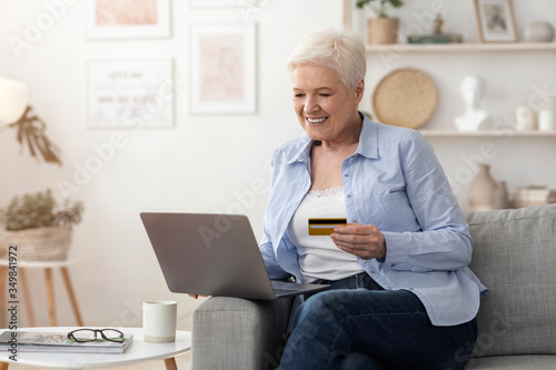 Online Payments. Senior Woman Using Laptop And Credit Card At Home
