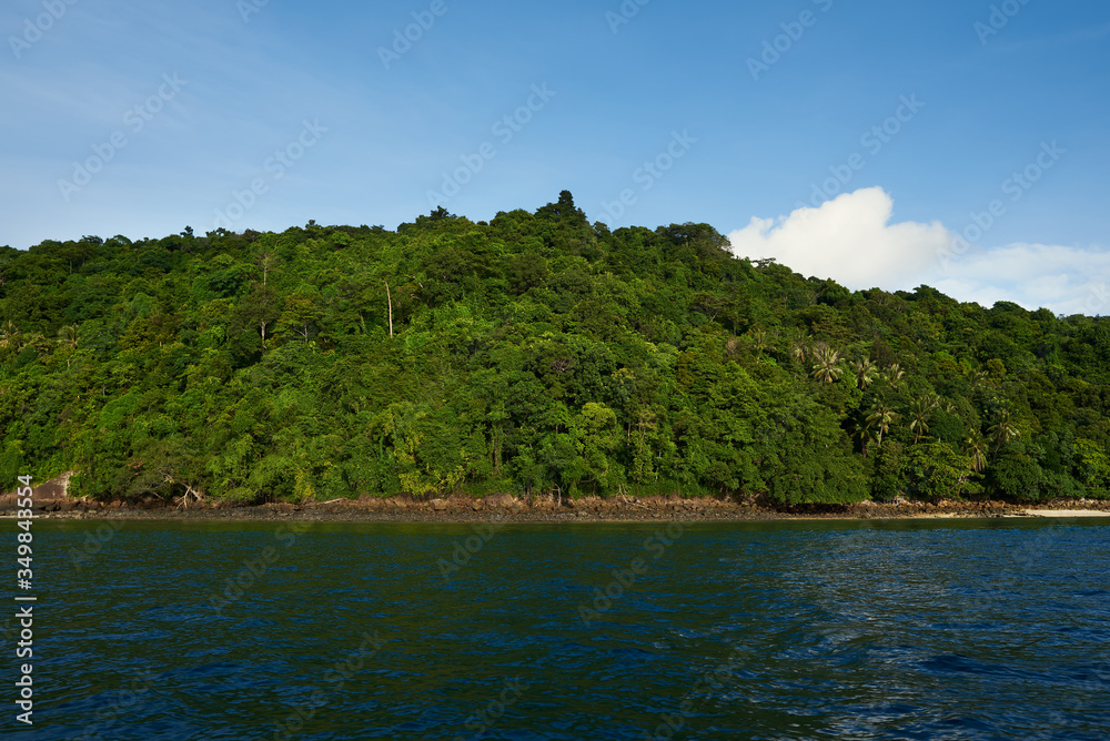 Boat trip in tropical sea to remote islands on the horizon