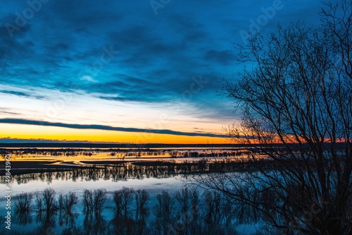 Beautiful landscape with flooded sushi with trees during spring flood at sunset day. View from above.