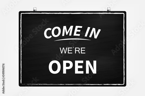 Text on vintage black sign "Come in we're open