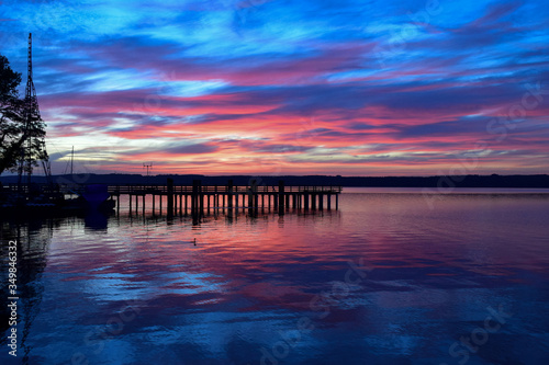Ein wundschöner Farbbetonter Natürlicher Rot/Oranger Sonnenaufgang am See. photo