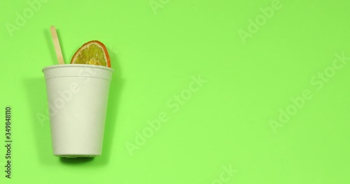 Stop motion making a drink with sugar and tea in a disposable bowl on a colored background