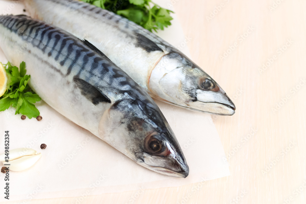 Two fresh mackerel with lemon and parsley, close-up Two fresh mackerel with lemon and parsley, close-up