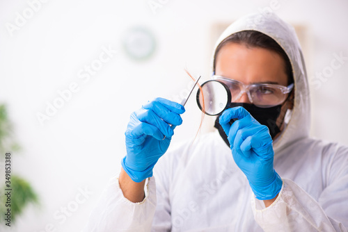 Male expert criminologist working in the lab for evidence photo