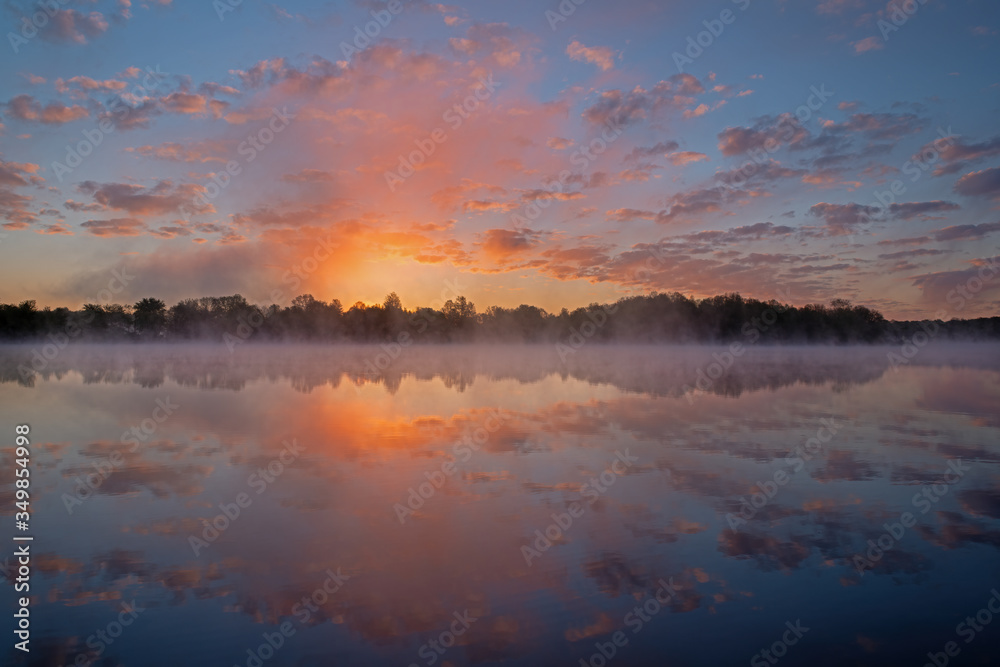 Landscape of a spring sunrise, Whitford Lake in light fog, Fort Custer State Park, Michigan, USA