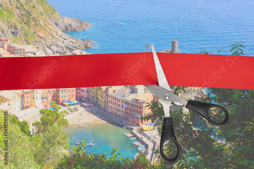 Sale of airline tickets. Scissors cut the red ribbon overlooking the picturesque village of Vernazza  Italy