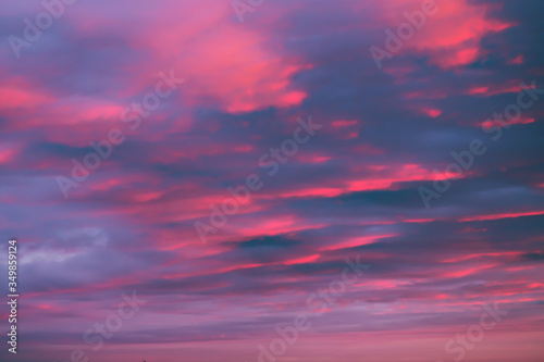 Dreamy romantic sky with clouds at sunset in pink-blue colors