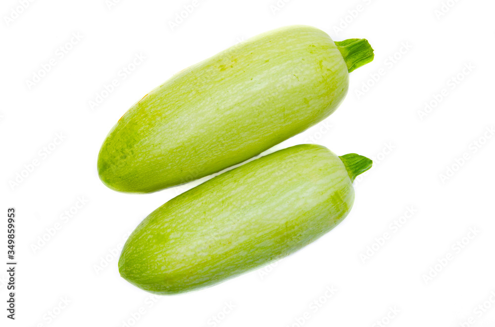 Young light green zucchini, organic natural on a white background. Zucchini sideways, on top. Two zucchini, zucchini tails Young light green zucchini, organic natural on a white background. Zucchini sideways, on top. Two zucchini, zucchini tails
