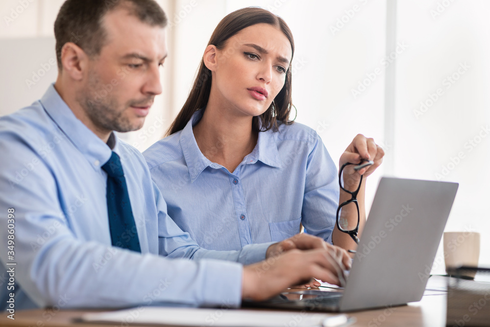 Businesswoman Checking Employee Man Working Using Laptop Sitting In Office Businesswoman Checking Employee Man Working Using Laptop Sitting In Office