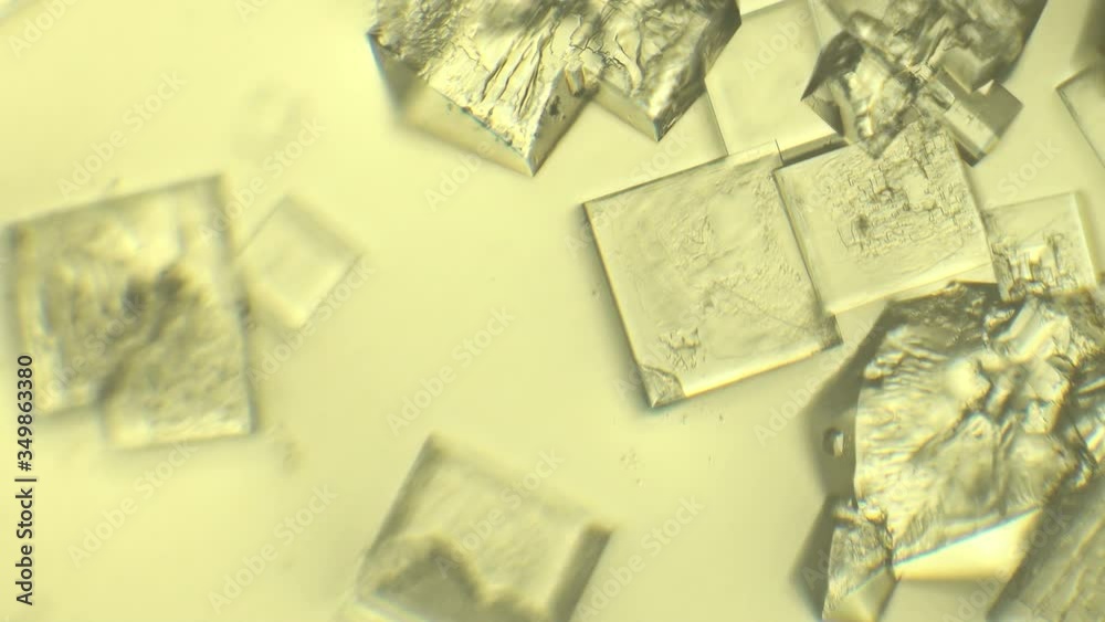 Many crystals in the drop under microscope. Crystallography and scientific research concept. Many crystals in the drop under microscope. Crystallography and scientific research concept.
