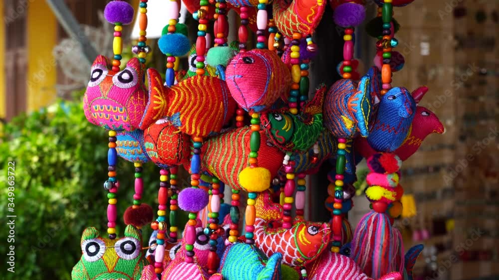 Colorful handmade souvenirs for sale in local street market in Hoi An, Vietnam, close up