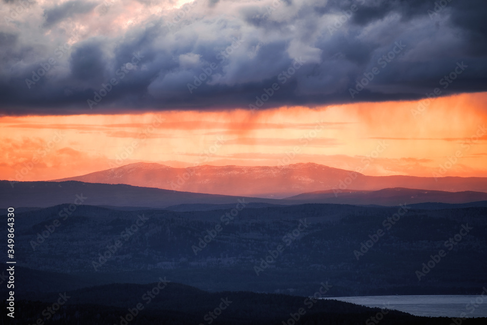 Orange Sun Setting Behind the Mountains