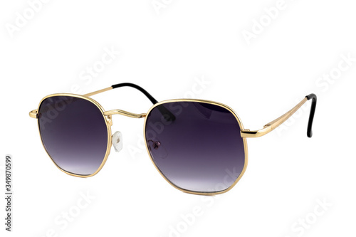 Sunglasses with dark blue color gradient lens and rectangle shaped gold thin metal frame, isolated on white background, side view.