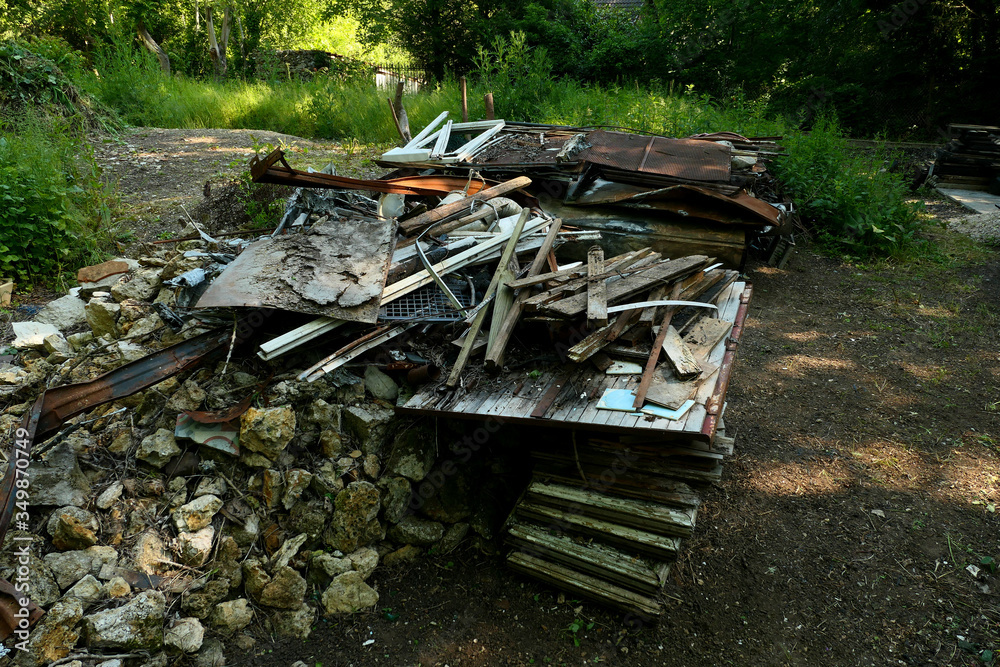 Wild discharge. Debris and rubbish. Heaps of scrap metal, and steel thrown into the wild. Household garbage abandoned in the wild. Environmental problem concept with pollution.