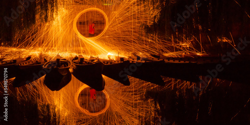 Whirl of sparks and flames at the river Neckar illuminating the local flat-bottomed boats (Stocherkahn) in Tuebingen, Germany