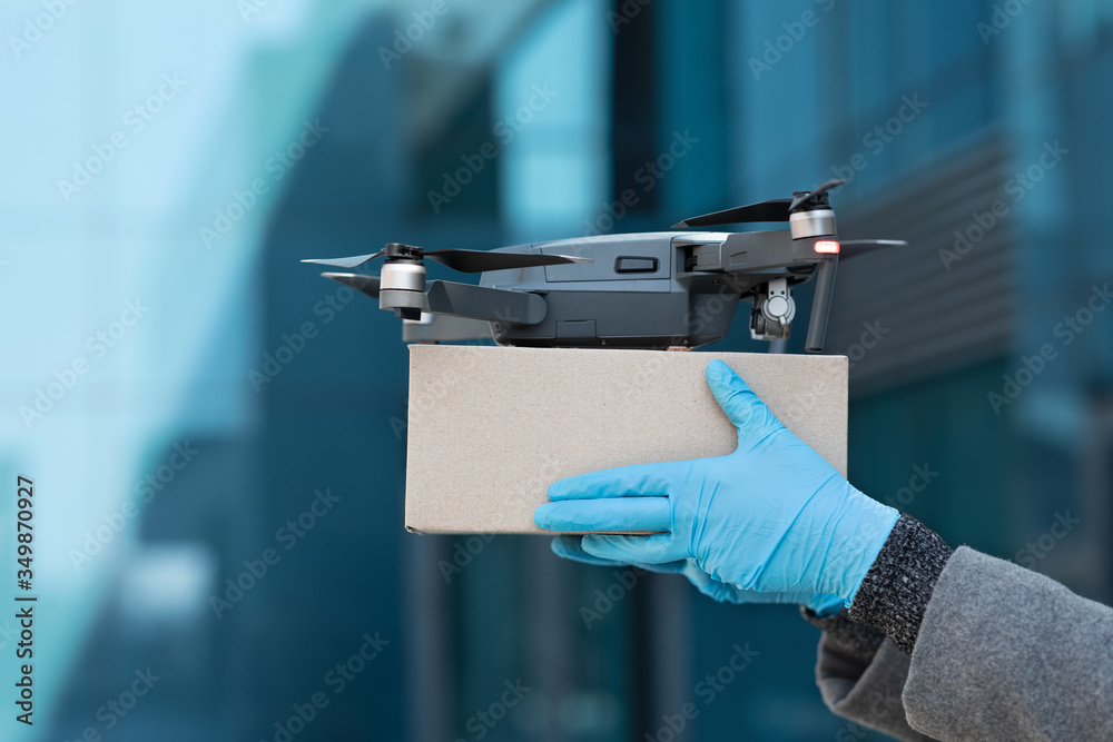 Drone delivering parcel to woman, contactless delivery