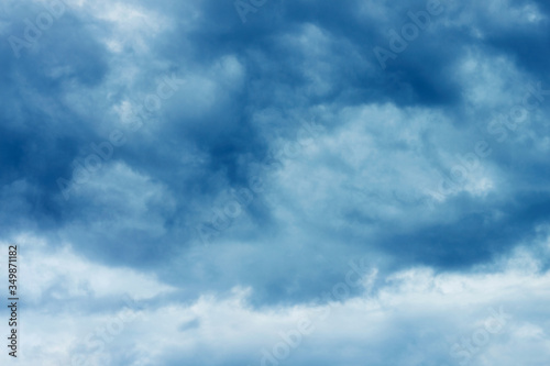 Blue sky with storm clouds. Concept bad cold weather, climate change, thinning of the ozone layer, acid rain.