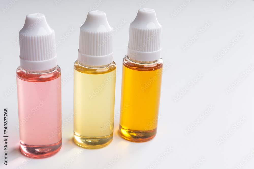 three e cigarettes liquid bottles on white background
three e cigarettes liquid bottles on white background