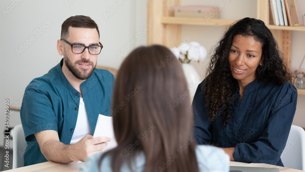 Close up focused african american businesswoman and businessman with resume listening applicant introduction. Front view confident diverse team in negotiation with woman job seeker at hire meeting. Close up focused african american businesswoman and businessman with resume listening applicant introduction. Front view confident diverse team in negotiation with woman job seeker at hire meeting.