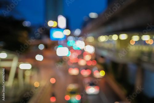 Blurred defocused lights of heavy traffic. Abstract blur image of night light bokeh on street. Blur traffic road with colorful bokeh light. Copy space of transportation and travel concept.