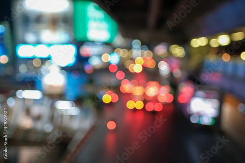 Blurred defocused lights of heavy traffic. Abstract blur image of night light bokeh on street. Blur traffic road with colorful bokeh light. Copy space of transportation and travel concept.