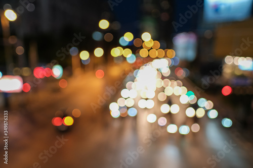 Blurred defocused lights of heavy traffic. Abstract blur image of night light bokeh on street. Blur traffic road with colorful bokeh light. Copy space of transportation and travel concept.