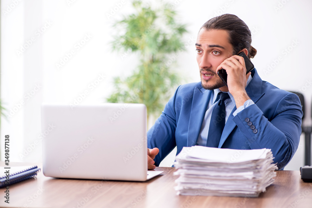 Young male businessman working in the office Young male businessman working in the office