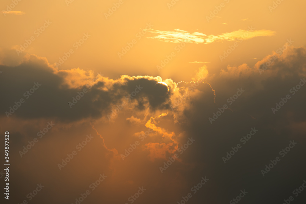 Close up of Sun rise in orange sky during cloudy in early morning; dawn and bright time