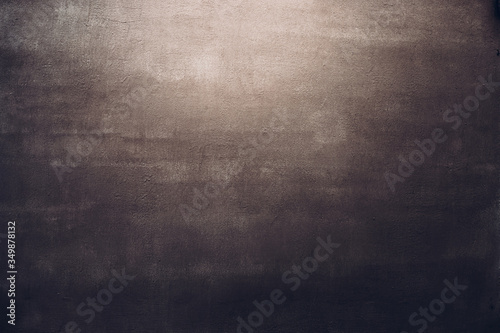 Dark brown concrete wall texture background in spot of light