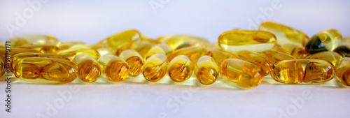 Yellow pills isolated on beautiful white background. Web banner with a copy space.