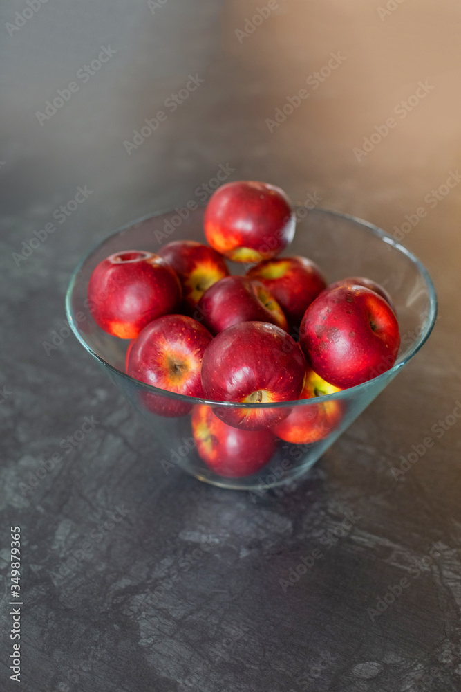 Red apples on a gray background. Ripe red apples in a glass container. Top view with space for your text. Organic food and healthy eating concept. Raw food, fruits. Red apples on a gray background. Ripe red apples in a glass container. Top view with space for your text. Organic food and healthy eating concept. Raw food, fruits.