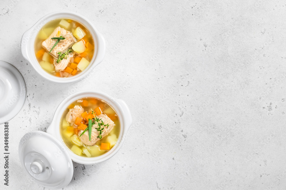 two ceramic pots of fish soup. Top view, copy space. two ceramic pots of fish soup. Top view, copy space.