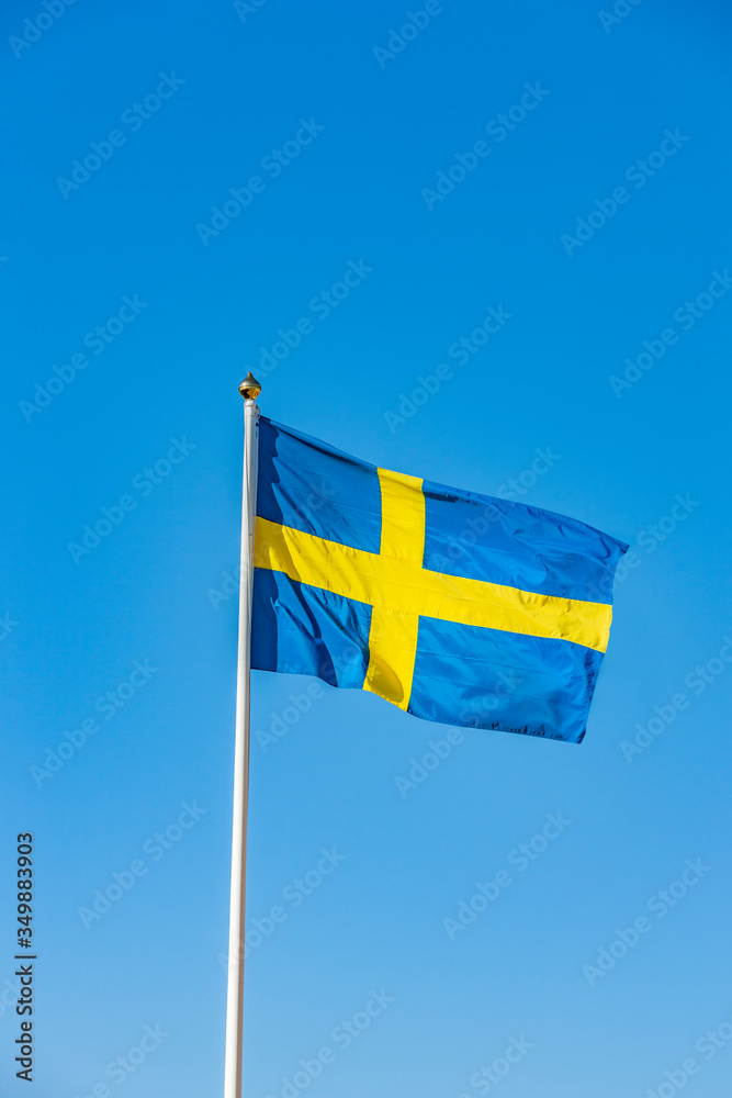 Schwedische Flagge im Wind vor Blauem Himmel Stock Photo | Adobe Stock